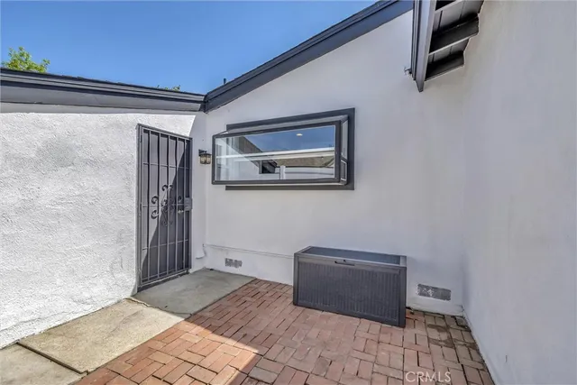 a view of a hallway with wooden floor and a bookshelf
