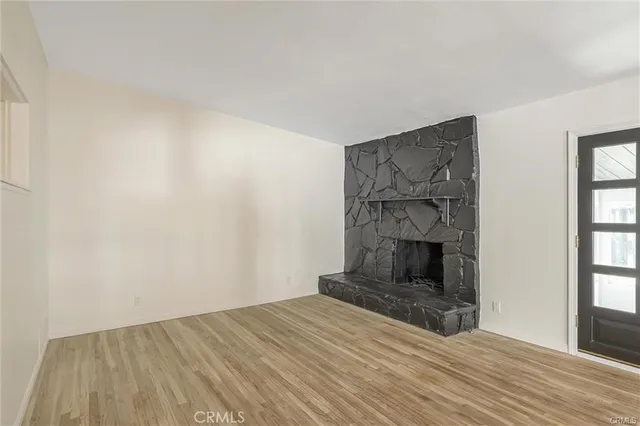 a room with a fireplace and wooden floor