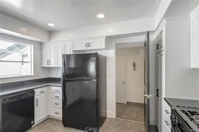 a kitchen with stainless steel appliances a refrigerator sink and cabinets