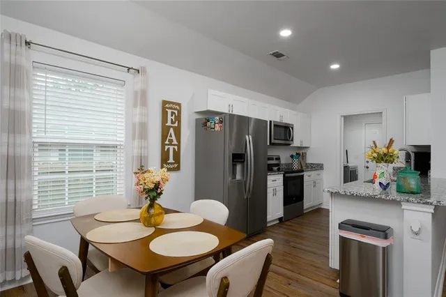 a kitchen with stainless steel appliances a stove microwave and cabinets