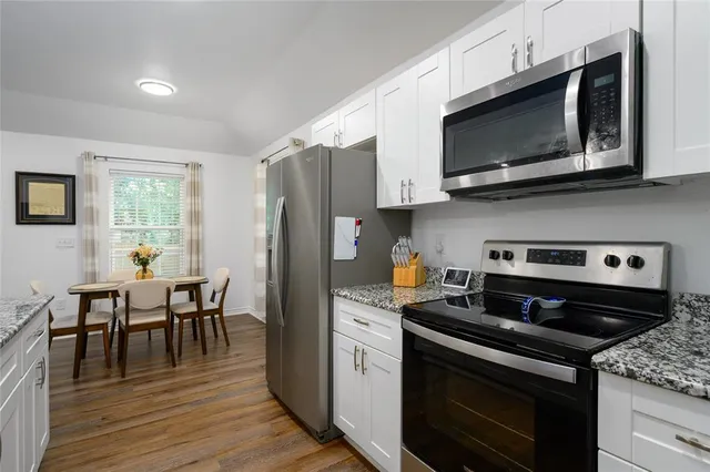 a kitchen with stainless steel appliances granite countertop a sink and a granite counter tops