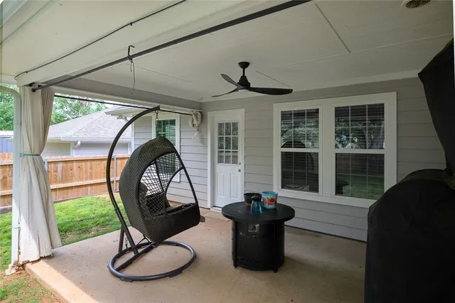 a backyard of a house with table and chairs