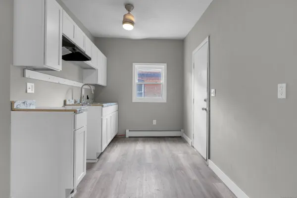 a view of a kitchen with electric appliances