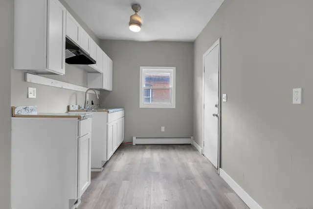 a view of a kitchen with electric appliances