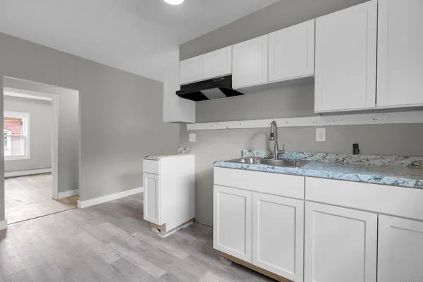 a kitchen with sink and cabinets
