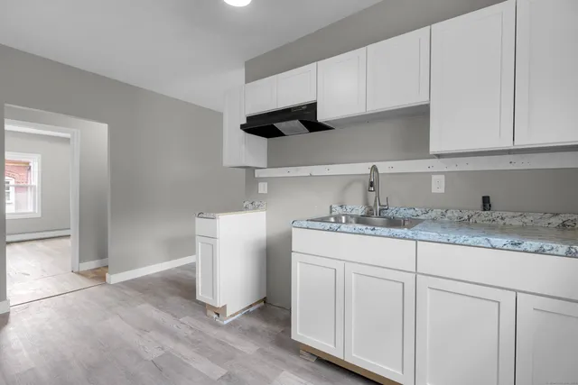 a kitchen with sink and cabinets