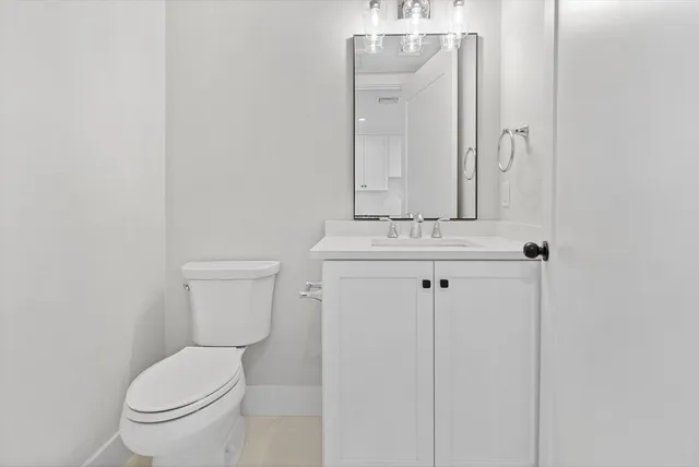 a white toilet sitting next to a bathroom sink
