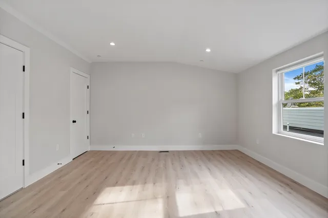 a view of room with window and hardwood floor