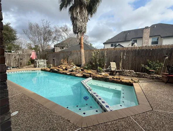 a view of a swimming pool with chairs