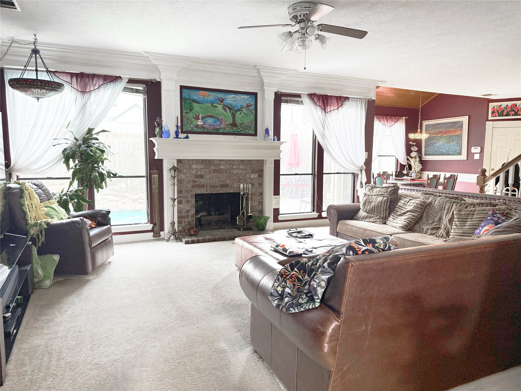 17310 Wyeth Circle Spring, TX 77379 - Photo 10 of 50 Den has more massive molding and a gas log fireplace flanked by floor to ceiling windows that offer a view of the pool