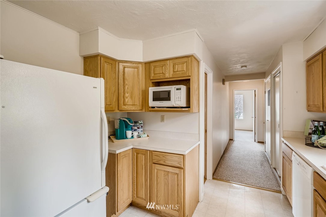23915 Brier Road Brier, WA 98036 - Photo 15 of 39 a hallway with cabinets washer and dryer