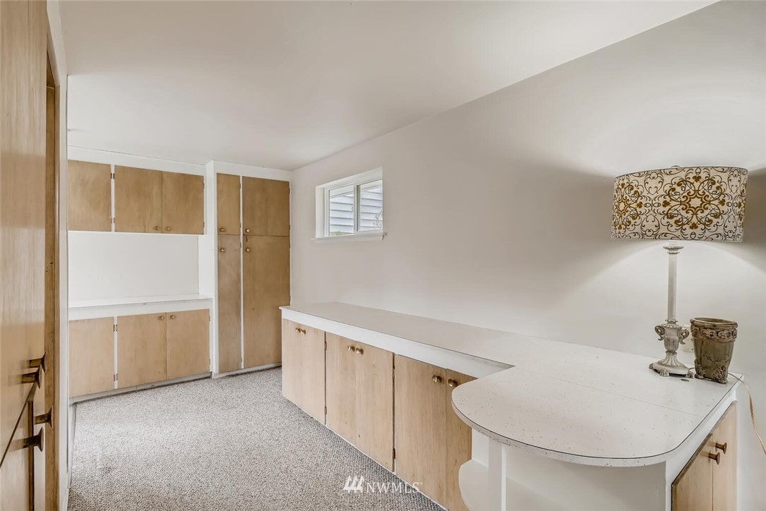 23915 Brier Road Brier, WA 98036 - Photo 22 of 39 a kitchen with white cabinets and a sink