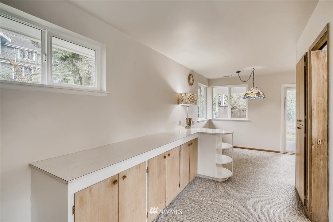 23915 Brier Road Brier, WA 98036 - Photo 23 of 39 a kitchen with white cabinets and white appliances