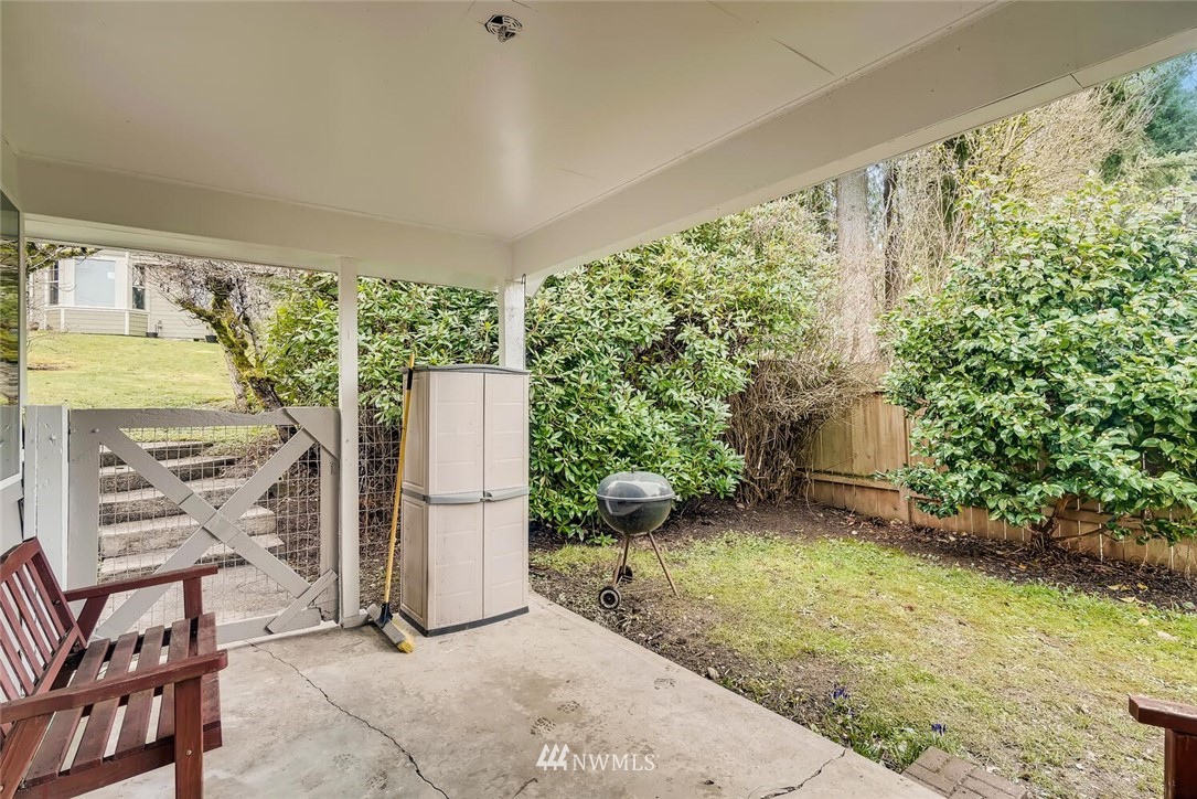 23915 Brier Road Brier, WA 98036 - Photo 30 of 39 a view of a backyard with chairs and floor to ceiling window