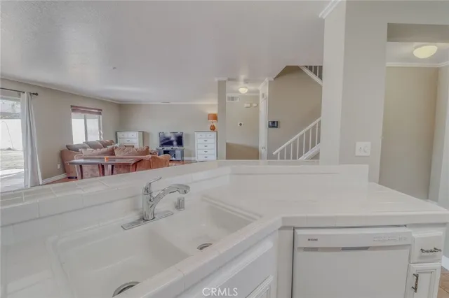 a kitchen with stainless steel appliances granite countertop a sink a stove and white cabinets