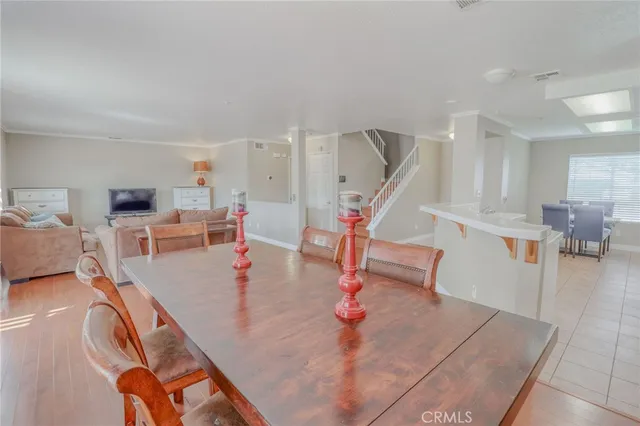 a dining room table with chairs and window