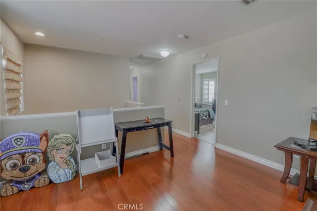 a room with a bed and a dresser in it