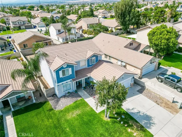 an aerial view of residential houses with green space