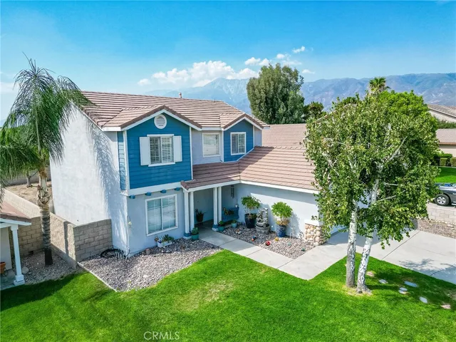a front view of a house with a garden and plants
