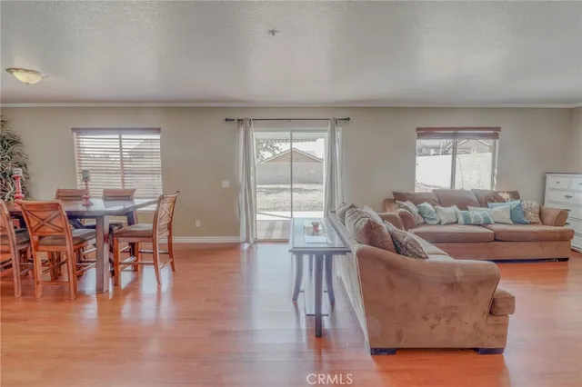 a living room with furniture wooden floor and a window