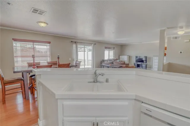 a kitchen with granite countertop a sink stove and cabinets