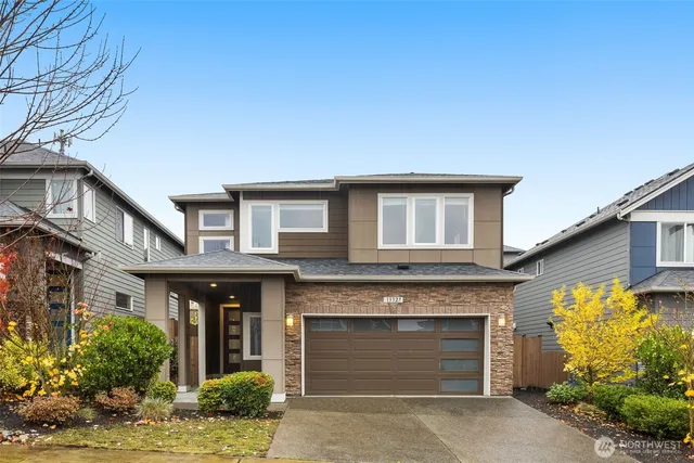 a front view of a house with garage