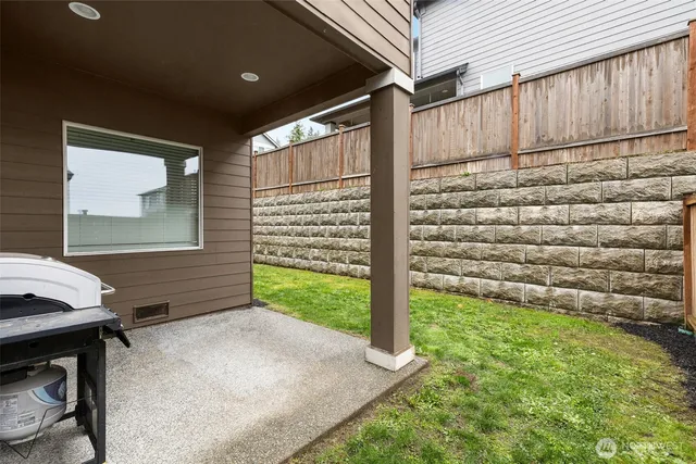 a view of a backyard with wooden fence