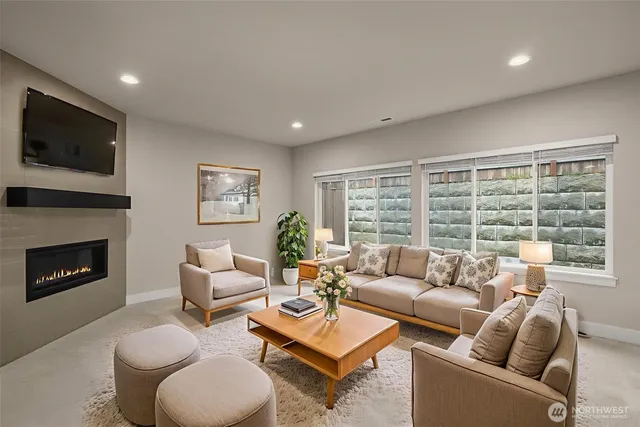 a view of an empty room with a window and fireplace