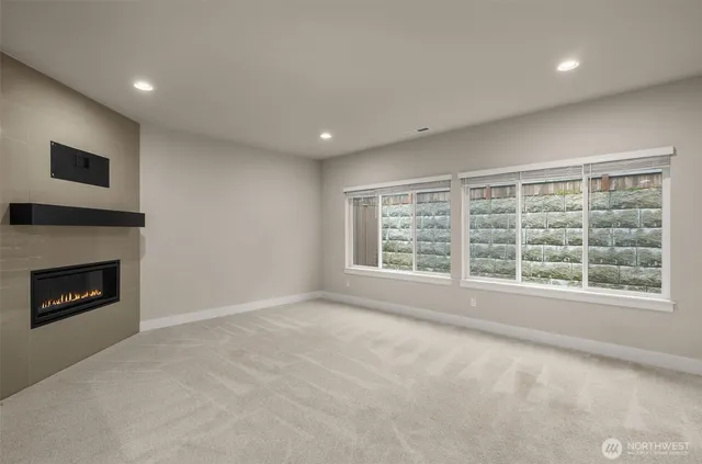 a view of empty room with a fireplace