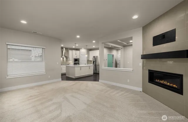 a kitchen with a sink a stove a refrigerator and white cabinets