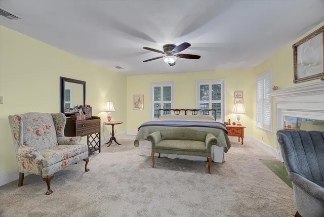 a bedroom with a bed a couch and a chandelier