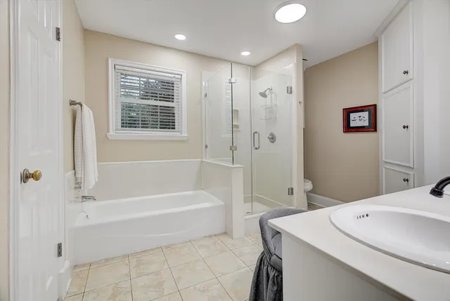 a bedroom with a bed and a ceiling fan