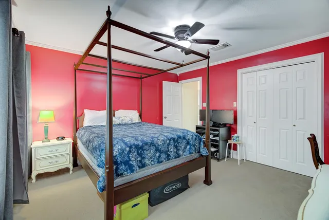 a bed sitting in a bedroom next to a window