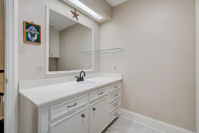 a bathroom with a sink and a mirror