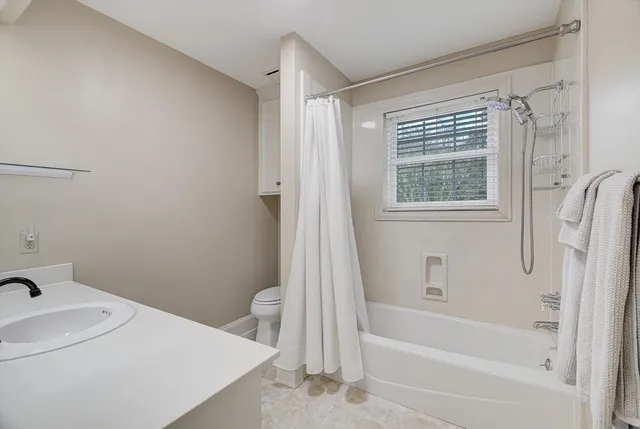 a kitchen with a sink and cabinets with wooden floor