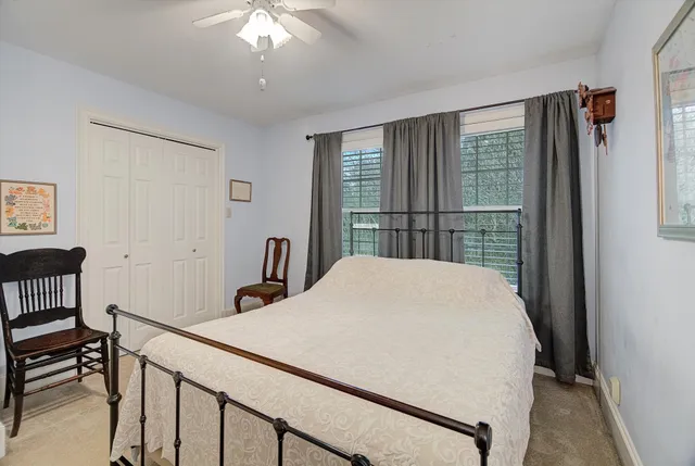 a bed sitting in a bedroom next to a window