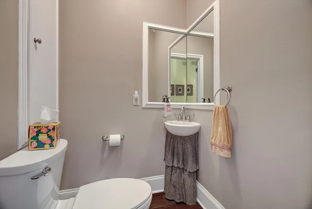 a bathroom with a sink toilet and mirror