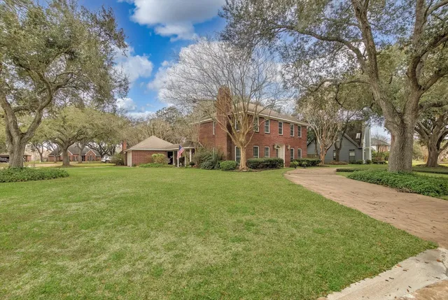 a view of house with outdoor space and garden