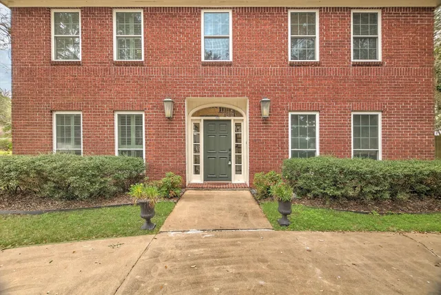 front view of brick house with a yard