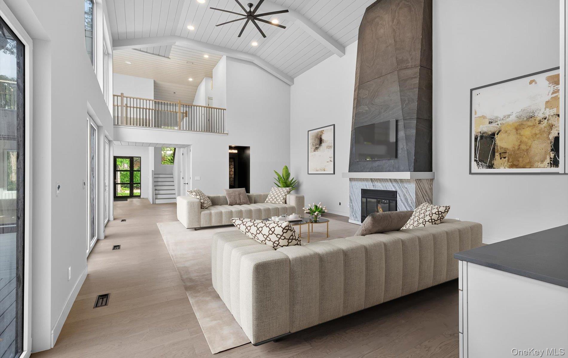 26 Windemere Way Woodbury, NY 11797 - Photo 13 of 40 a living room with furniture a fireplace and a chandelier