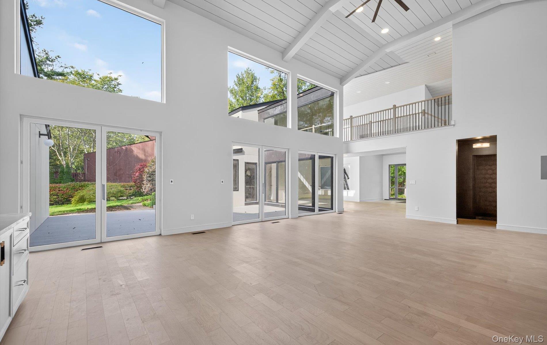 26 Windemere Way Woodbury, NY 11797 - Photo 17 of 40 a view of an empty room with floor to ceiling windows
