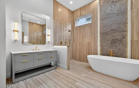 a bathroom with a sink a mirror and a bathtub