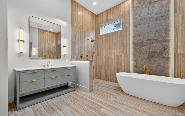 a bathroom with a sink a mirror and a bathtub