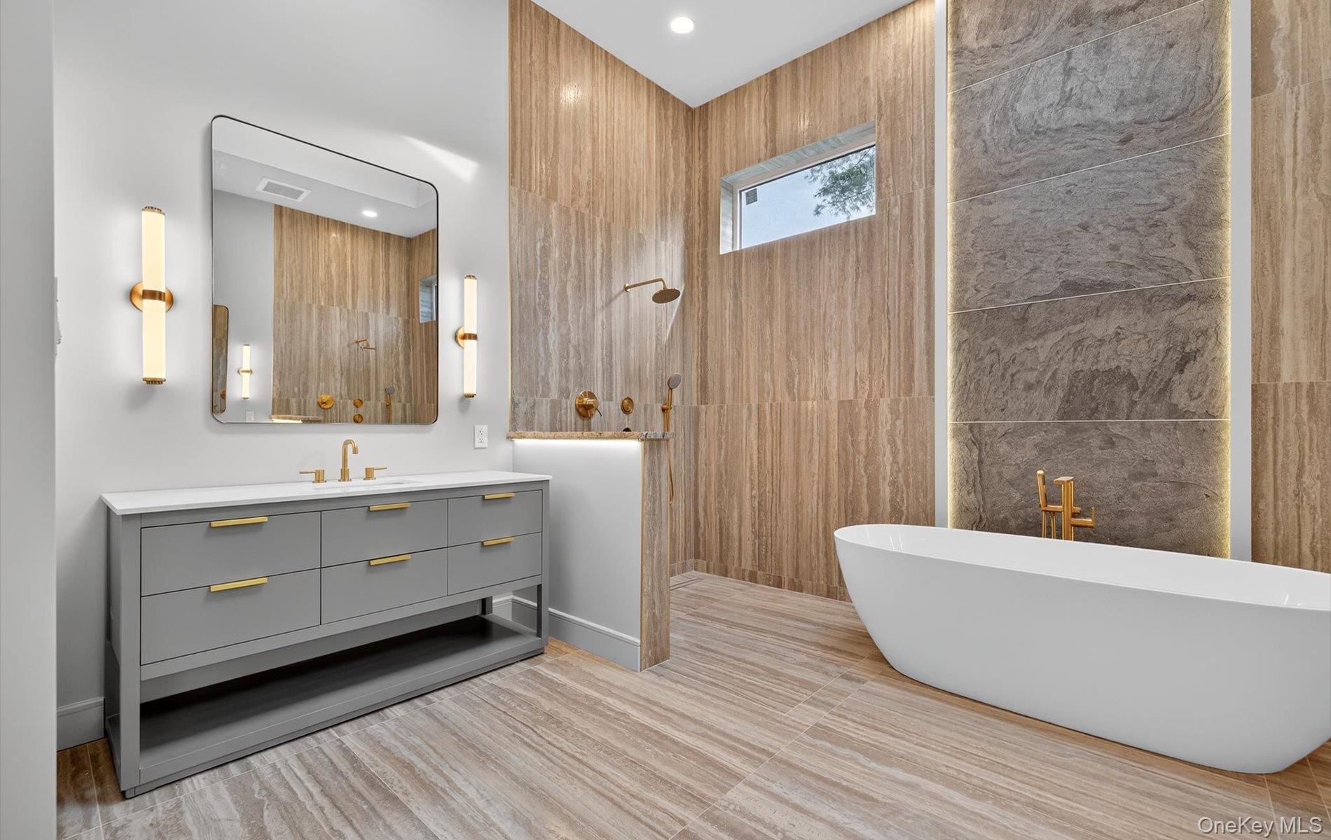 26 Windemere Way Woodbury, NY 11797 - Photo 20 of 40 a bathroom with a double vanity sink a mirror and a bathtub