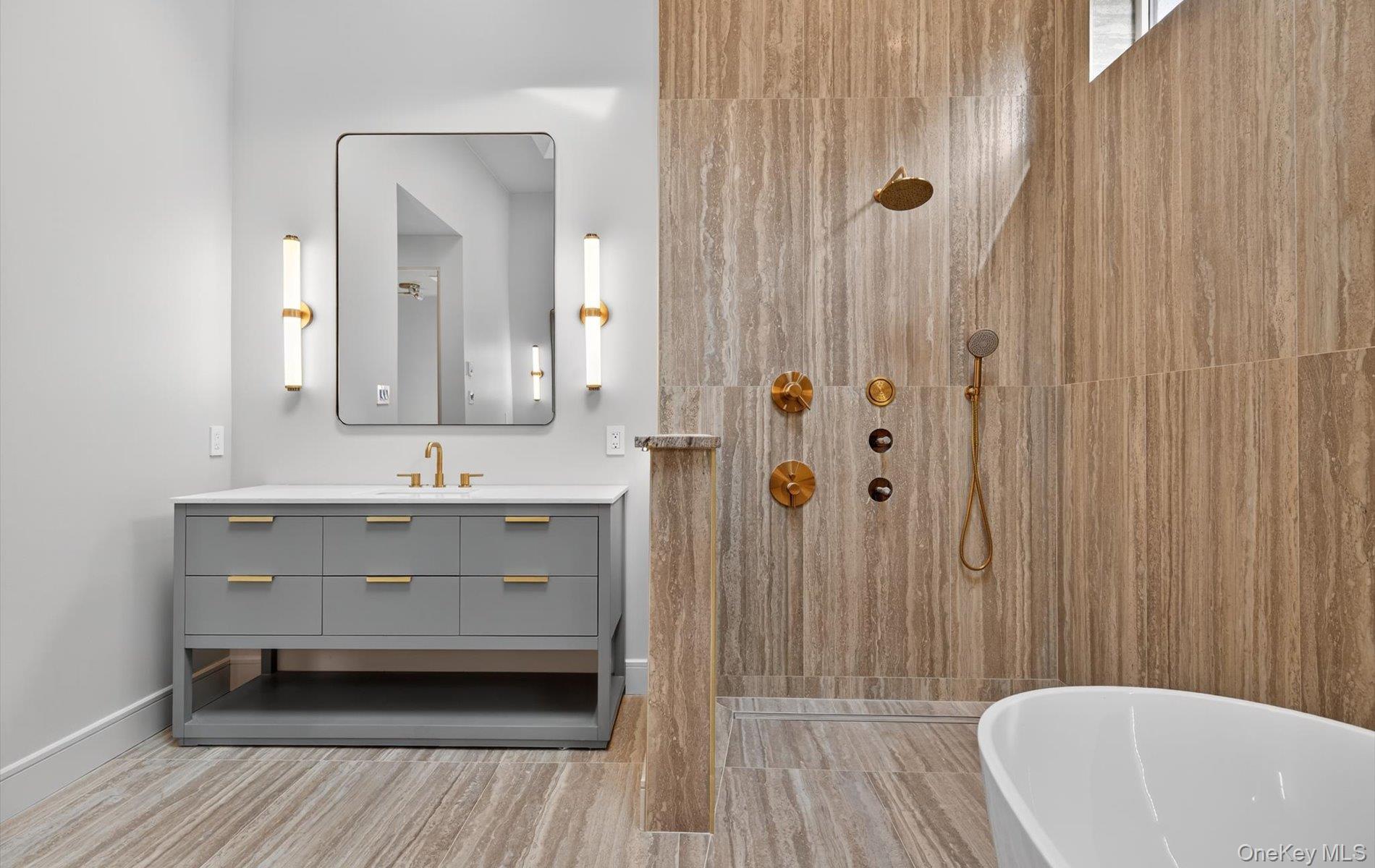 26 Windemere Way Woodbury, NY 11797 - Photo 21 of 40 a bathroom with a sink a mirror and a bathtub