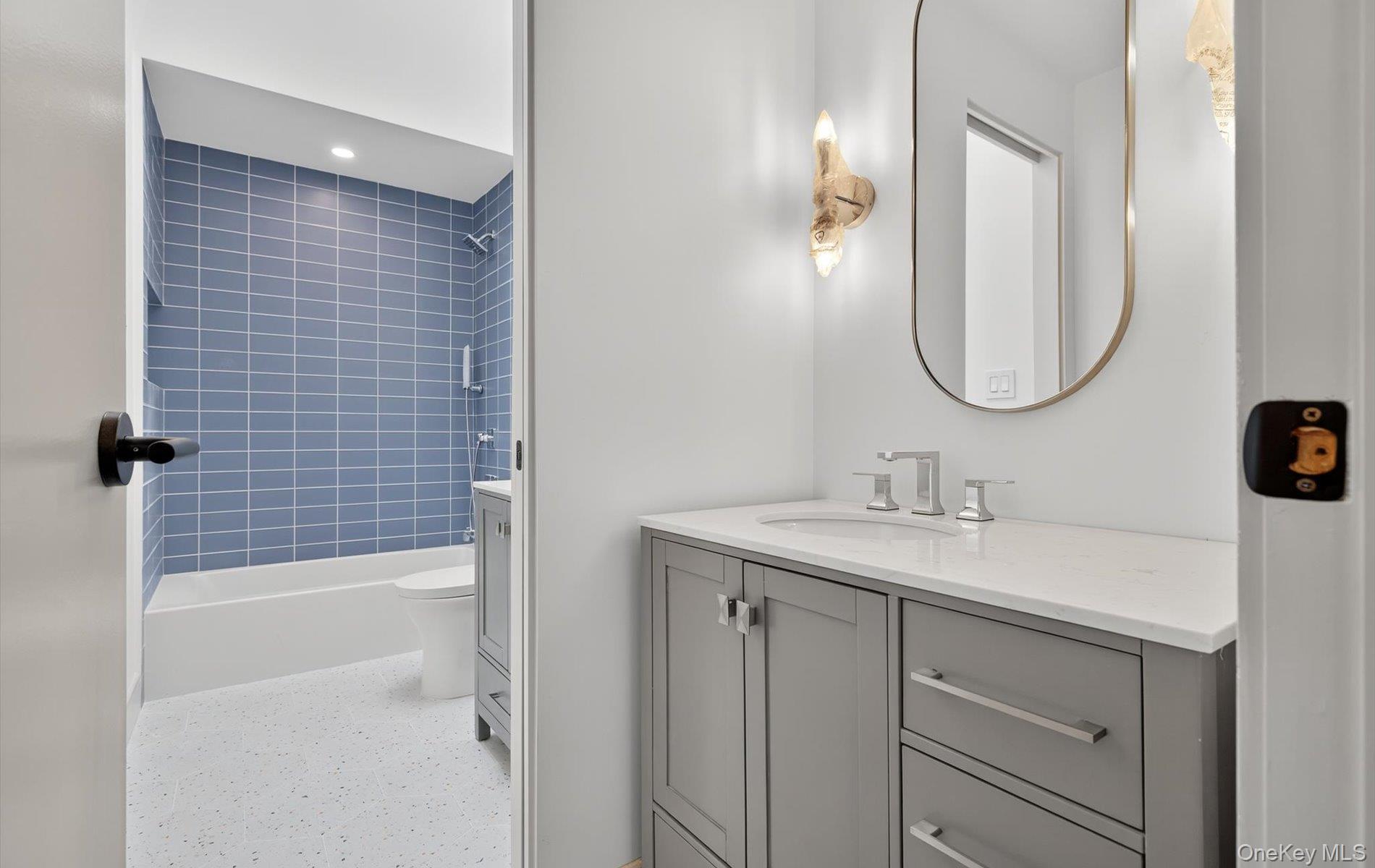 26 Windemere Way Woodbury, NY 11797 - Photo 28 of 40 a bathroom with a sink a toilet and shower