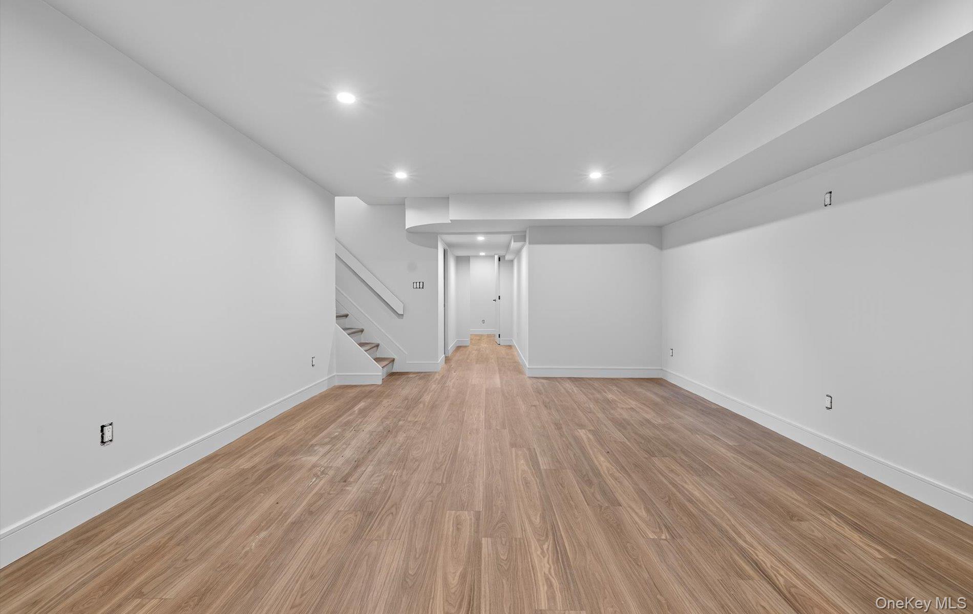 26 Windemere Way Woodbury, NY 11797 - Photo 29 of 40 a view of empty room with wooden floor