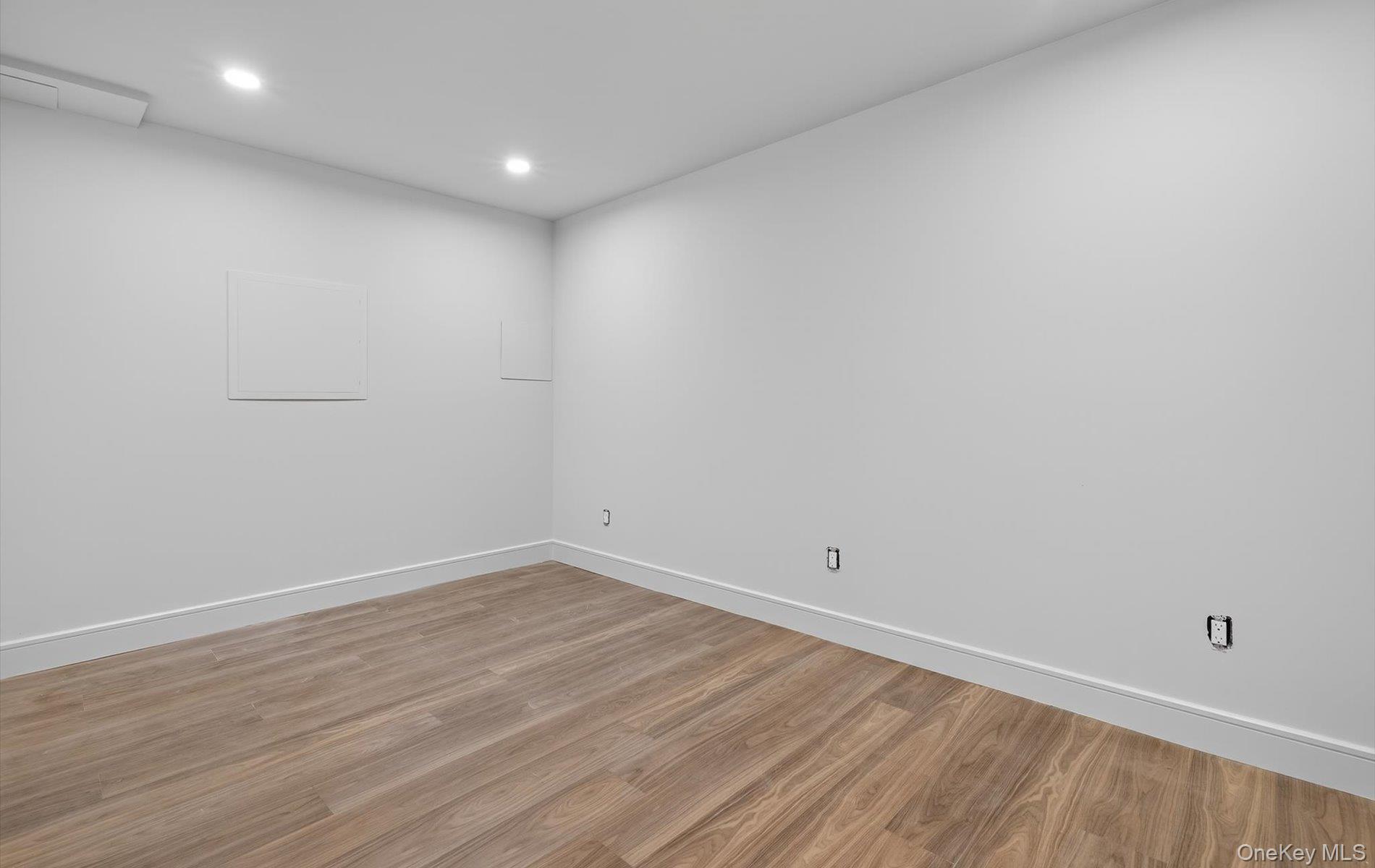 26 Windemere Way Woodbury, NY 11797 - Photo 30 of 40 a view of room with wooden floor