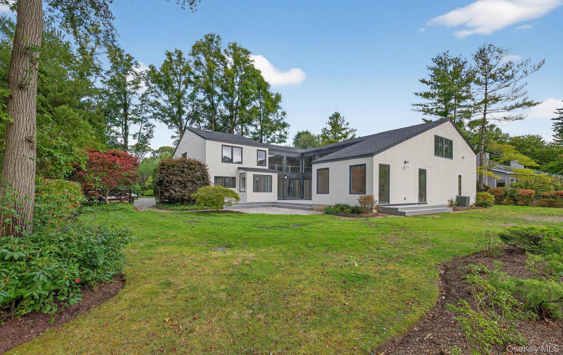 26 Windemere Way Woodbury, NY 11797 - Photo 34 of 40 a view of a house with backyard and garden