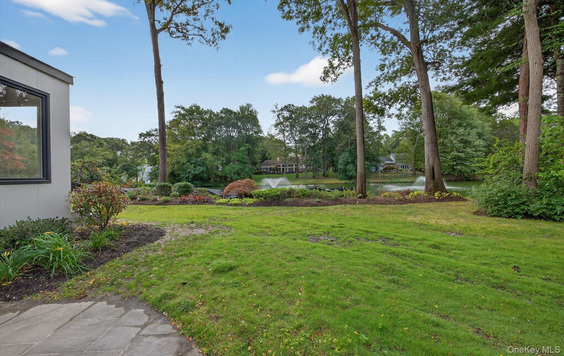 26 Windemere Way Woodbury, NY 11797 - Photo 35 of 40 a view of outdoor space with deck and garden